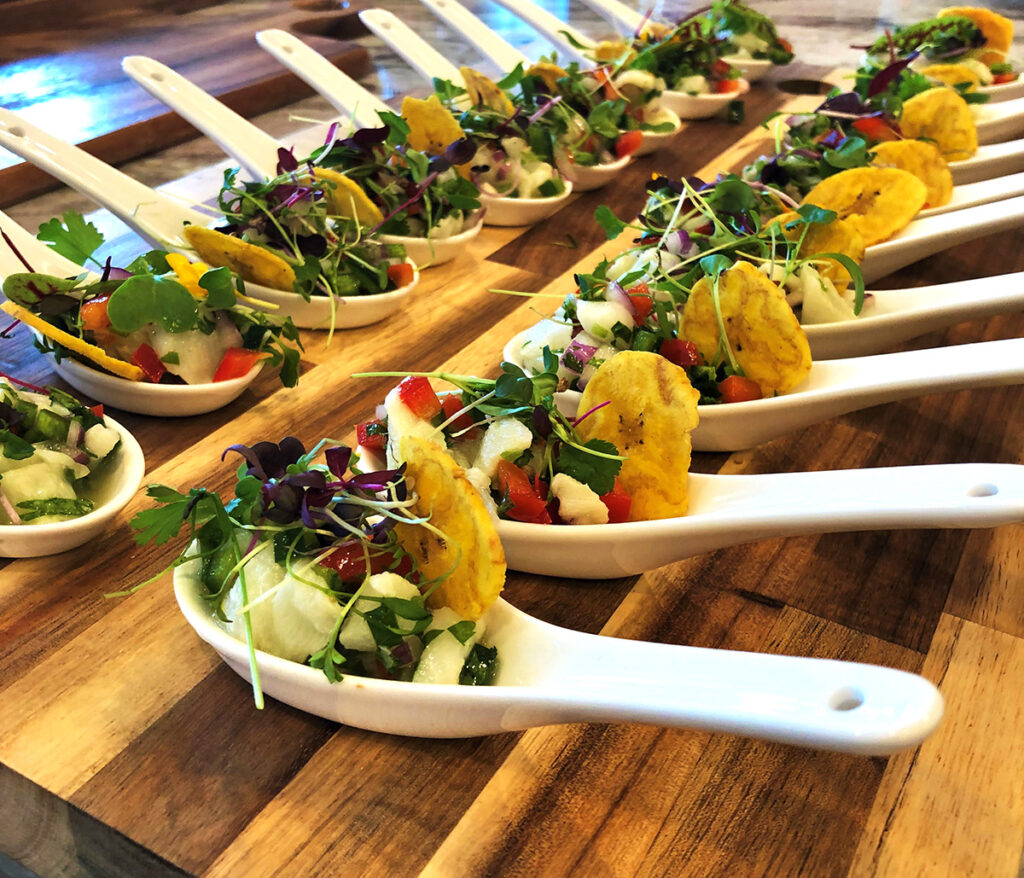 small bite plates adorned with fresh veggies and fried plantains on the side